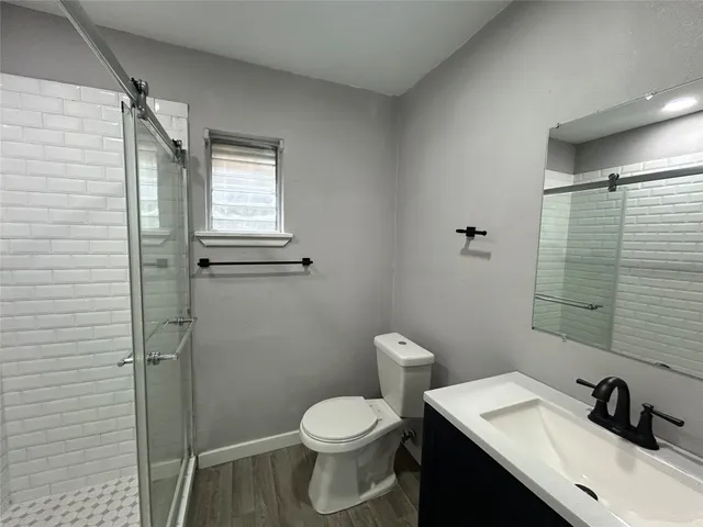 a bathroom with a sink toilet and shower