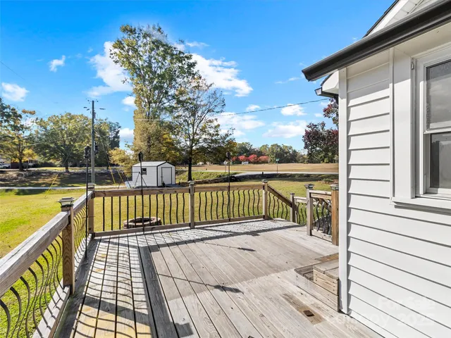 a view of a balcony with wooden fence