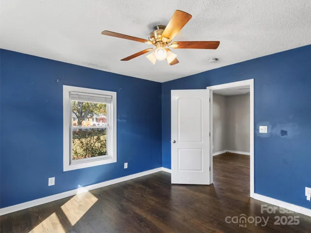 a kitchen with refrigerator cabinets and wooden floor