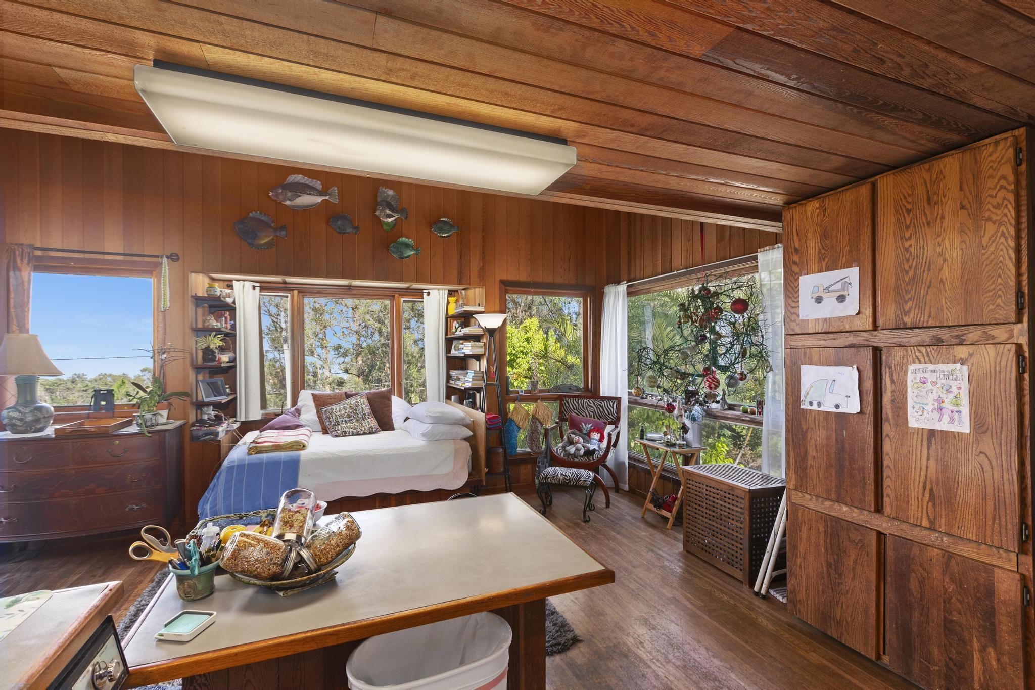 2450 Piiholo Road Makawao, HI 96768 - Photo 27 of 39 a living room with furniture a large window and wooden floor