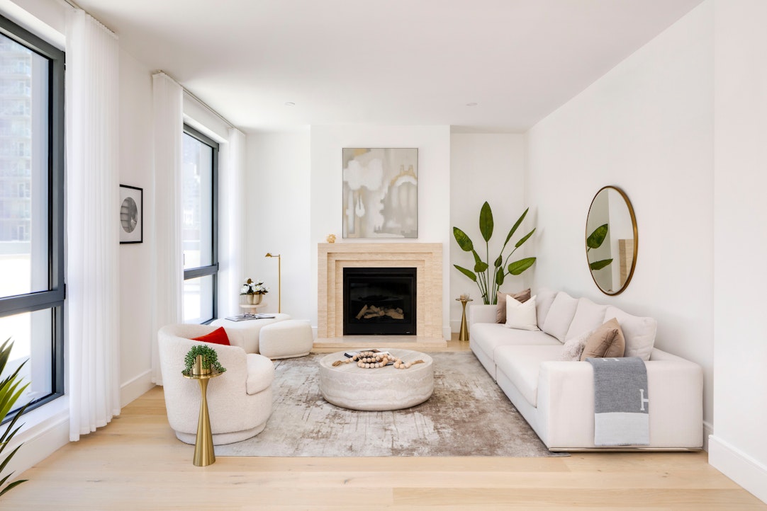 244 East 52nd Street, Unit PH7 Manhattan, NY 10022 - Photo 1 of 23 a living room with furniture and a fireplace