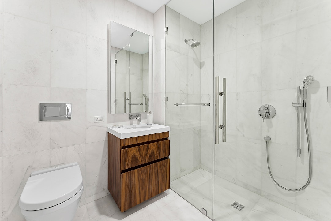 244 East 52nd Street, Unit PH7 Manhattan, NY 10022 - Photo 14 of 23 a bathroom with a toilet sink and shower