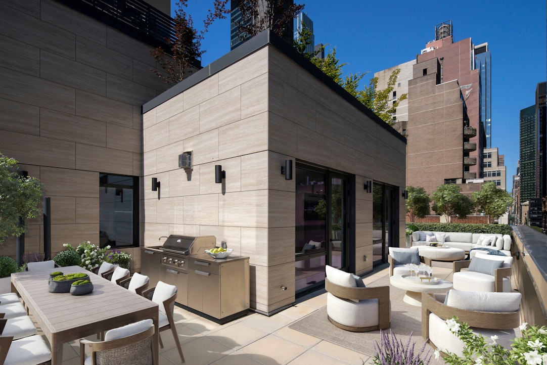244 East 52nd Street, Unit PH7 Manhattan, NY 10022 - Photo 2 of 23 a view of a patio with table and chairs and potted plants