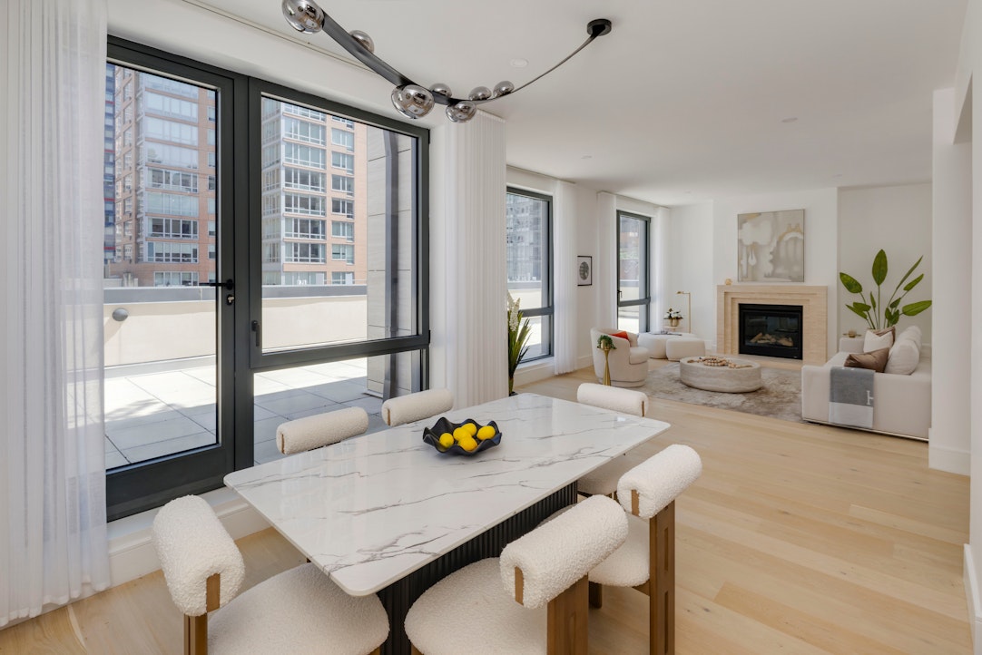 244 East 52nd Street, Unit PH7 Manhattan, NY 10022 - Photo 3 of 23 a living room with furniture fireplace and a table