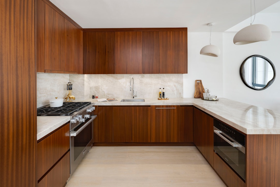 244 East 52nd Street, Unit PH7 Manhattan, NY 10022 - Photo 4 of 23 a kitchen with a sink dishwasher stove and cabinets