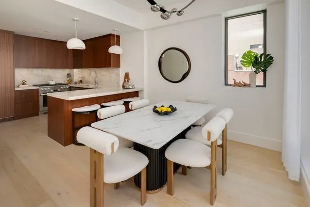 a kitchen with a sink dishwasher stove and cabinets