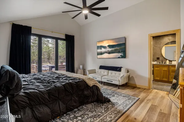 a view of empty room with wooden floor and floor to ceiling window
