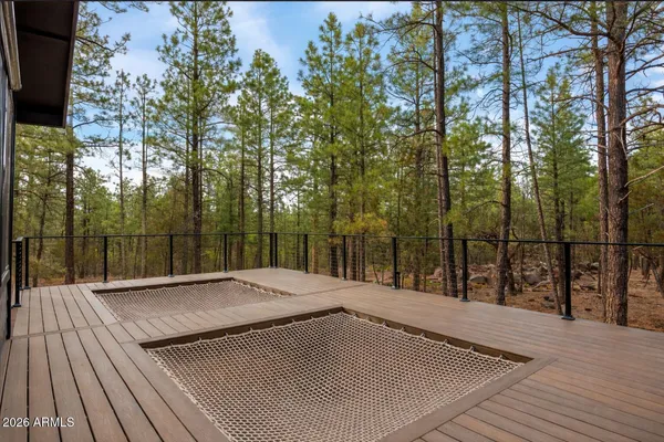 a view of a deck with couches table and chairs and wooden floor