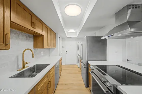 a kitchen with granite countertop a sink and a stove top oven