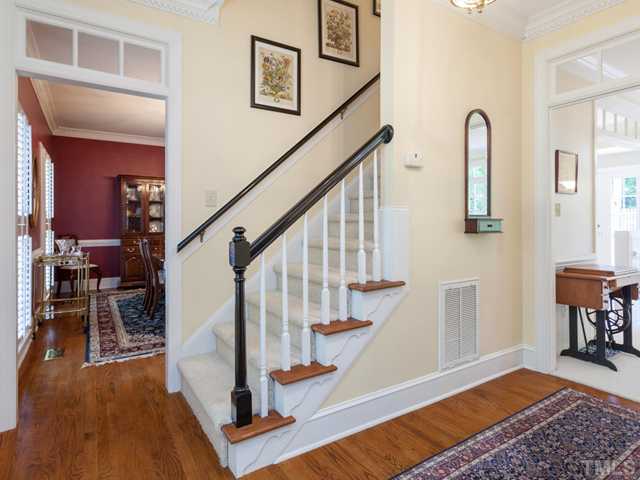 1917 Prescott Place Raleigh, NC 27615 - Photo 3 of 25 The welcoming foyer features hardwood floors and transoms over the doorways.