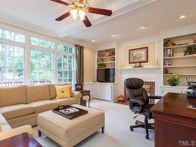 1917 Prescott Place Raleigh, NC 27615 - Photo 5 of 25 The family room offers twin bookcases, a gas fireplace with brick surround, recessed lighting and a beamed ceiling.