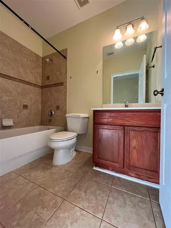 a spacious bathroom with a toilet and a mirror
