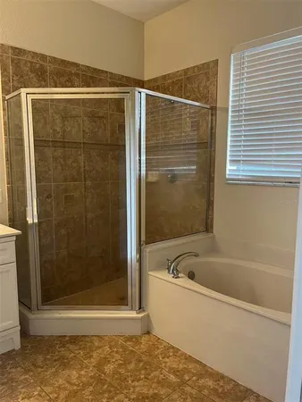 a bathroom with a bathtub and shower