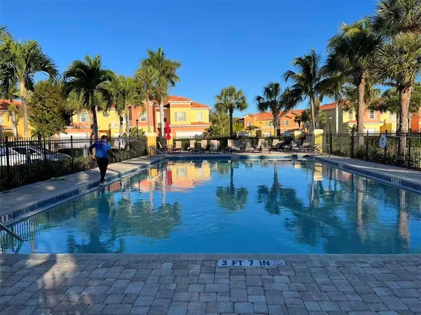 a view of swimming pool with outdoor seating