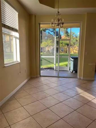 a view of a room with wooden floor windows and chandelier