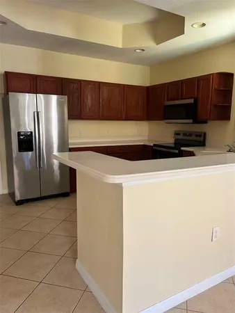 a kitchen with stainless steel appliances a refrigerator a stove a microwave and sink