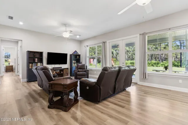 a view of a workspace with furniture and wooden floor