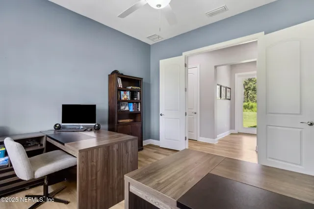 a backyard of a house with fire pit and outdoor seating