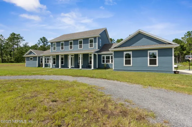 a view of a dining room with furniture a chandelier and wooden floor