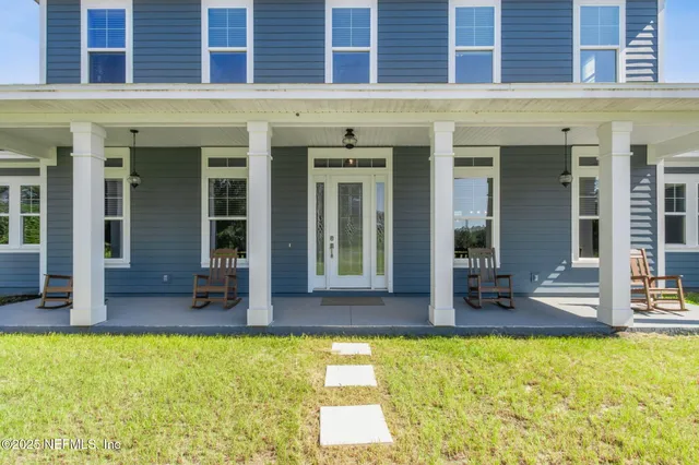 a kitchen with stainless steel appliances kitchen island granite countertop a stove a sink a oven a dining table and chairs