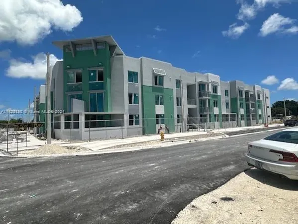 a view of a street with a building in the background