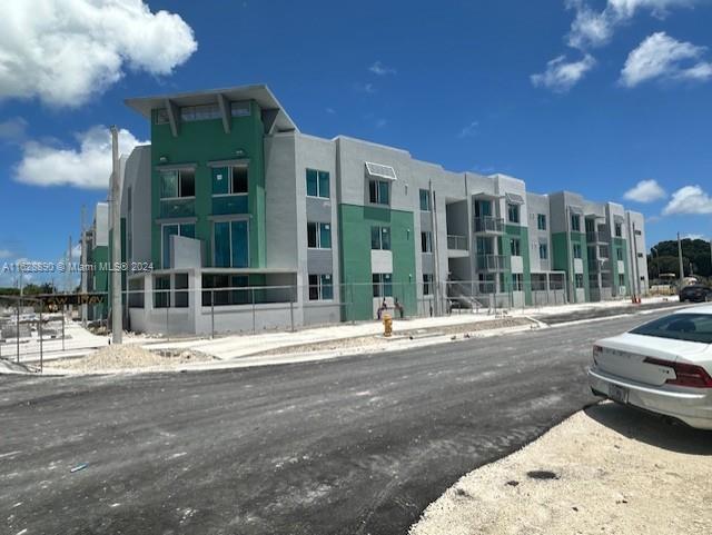 11912 Southwest 217th Street Miami, FL 33170 - Photo 3 of 3 a view of a street with a building in the background