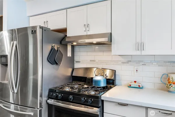a kitchen with a refrigerator and a stove