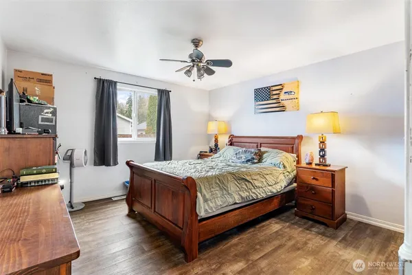 a bedroom with a bed and a chandelier