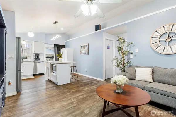 a living room with furniture and kitchen view