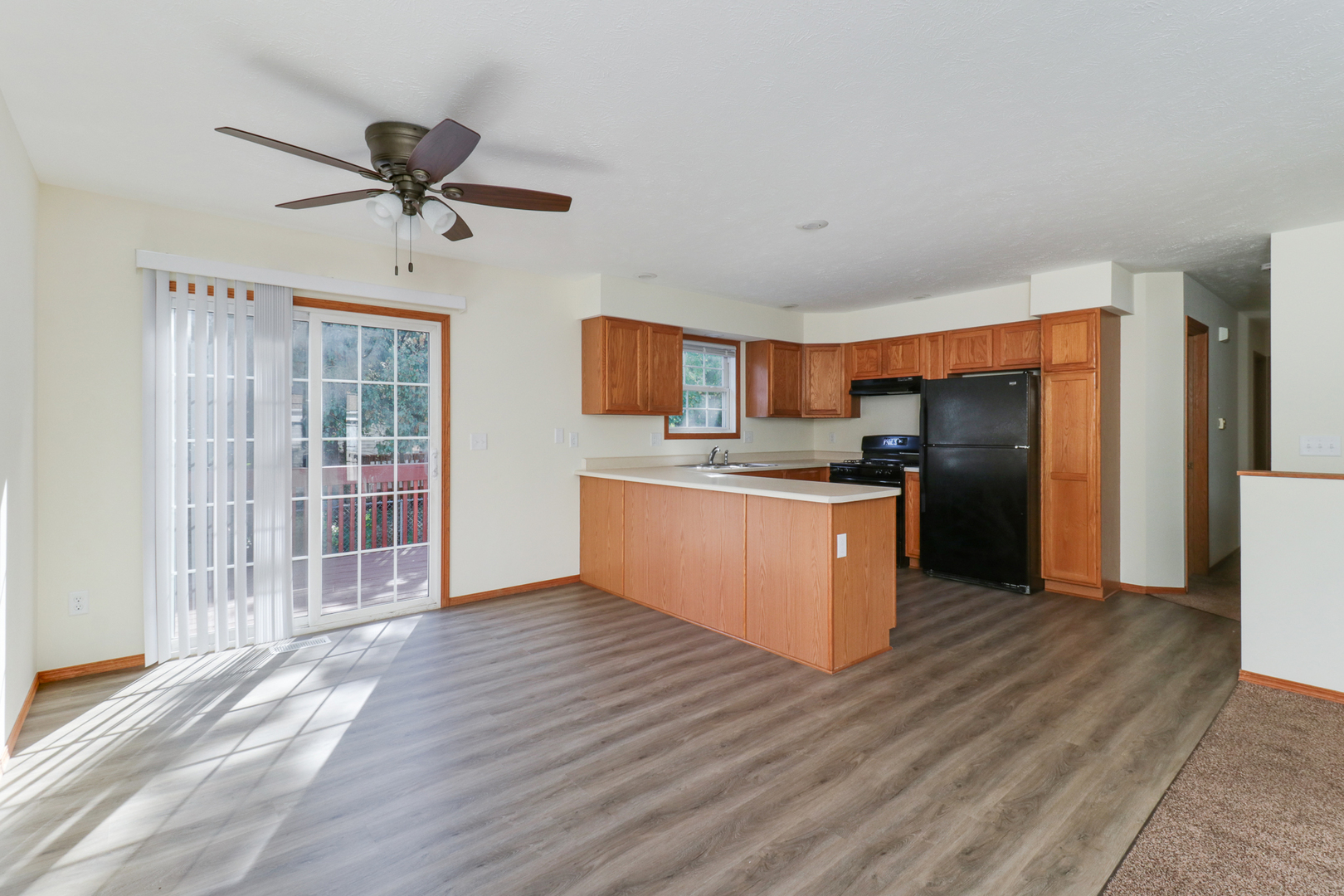 205 Martin Street Normal, IL 61761 - Photo 6 of 32 a large kitchen with stainless steel appliances kitchen island a large counter top and a wooden floors
