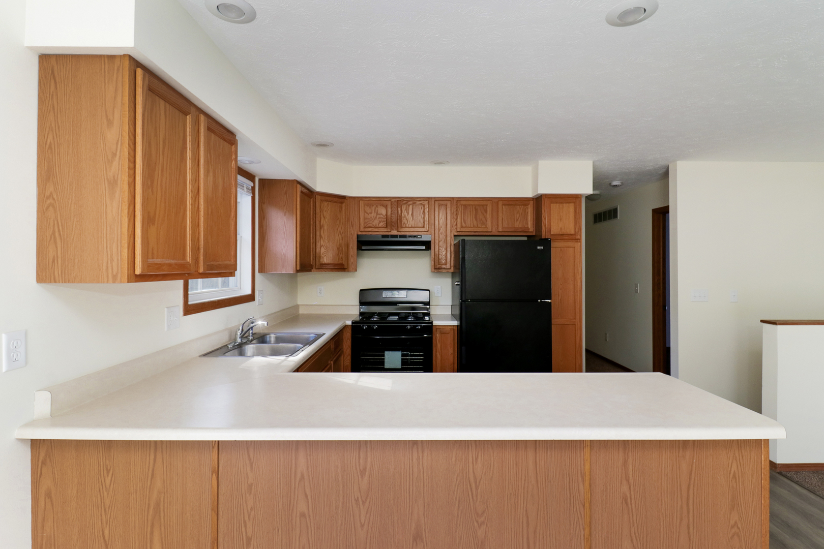 205 Martin Street Normal, IL 61761 - Photo 8 of 32 a kitchen with stainless steel appliances a refrigerator a sink a stove a microwave and wooden cabinets