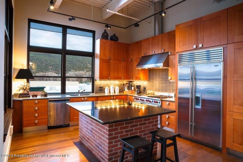 231 Robinson Street, Unit 325 Basalt, CO 81621 - Photo 5 of 16 a kitchen with stainless steel appliances granite countertop a sink and a refrigerator