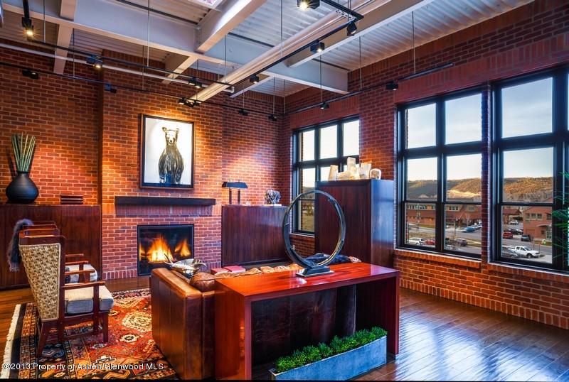 231 Robinson Street, Unit 325 Basalt, CO 81621 - Photo 7 of 16 a living room with furniture a fireplace and wooden floors