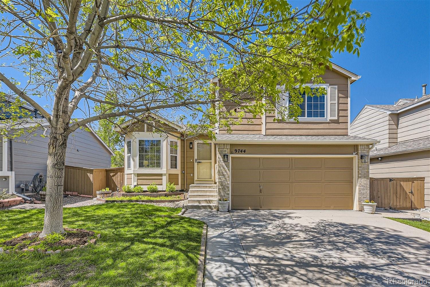 a front view of a house with a yard and garage
