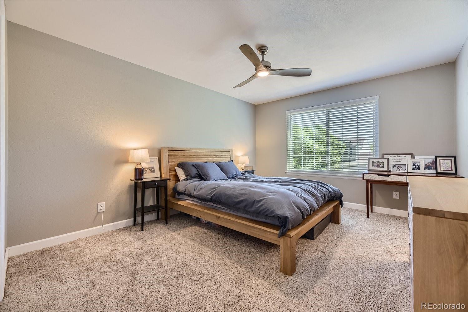 9744 South Castle Ridge Circle Highlands Ranch, CO 80129 - Photo 16 of 28 a spacious bedroom with a bed and window