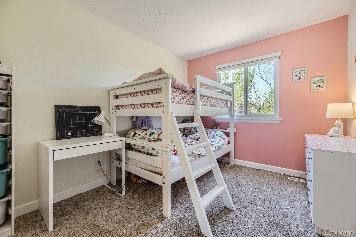 9744 South Castle Ridge Circle Highlands Ranch, CO 80129 - Photo 21 of 28 a bed room with a bed and a window
