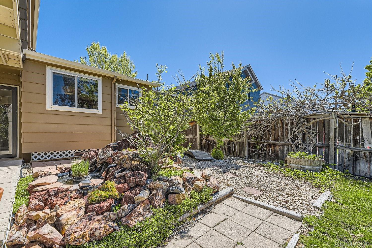 9744 South Castle Ridge Circle Highlands Ranch, CO 80129 - Photo 23 of 28 a front view of a house with a yard