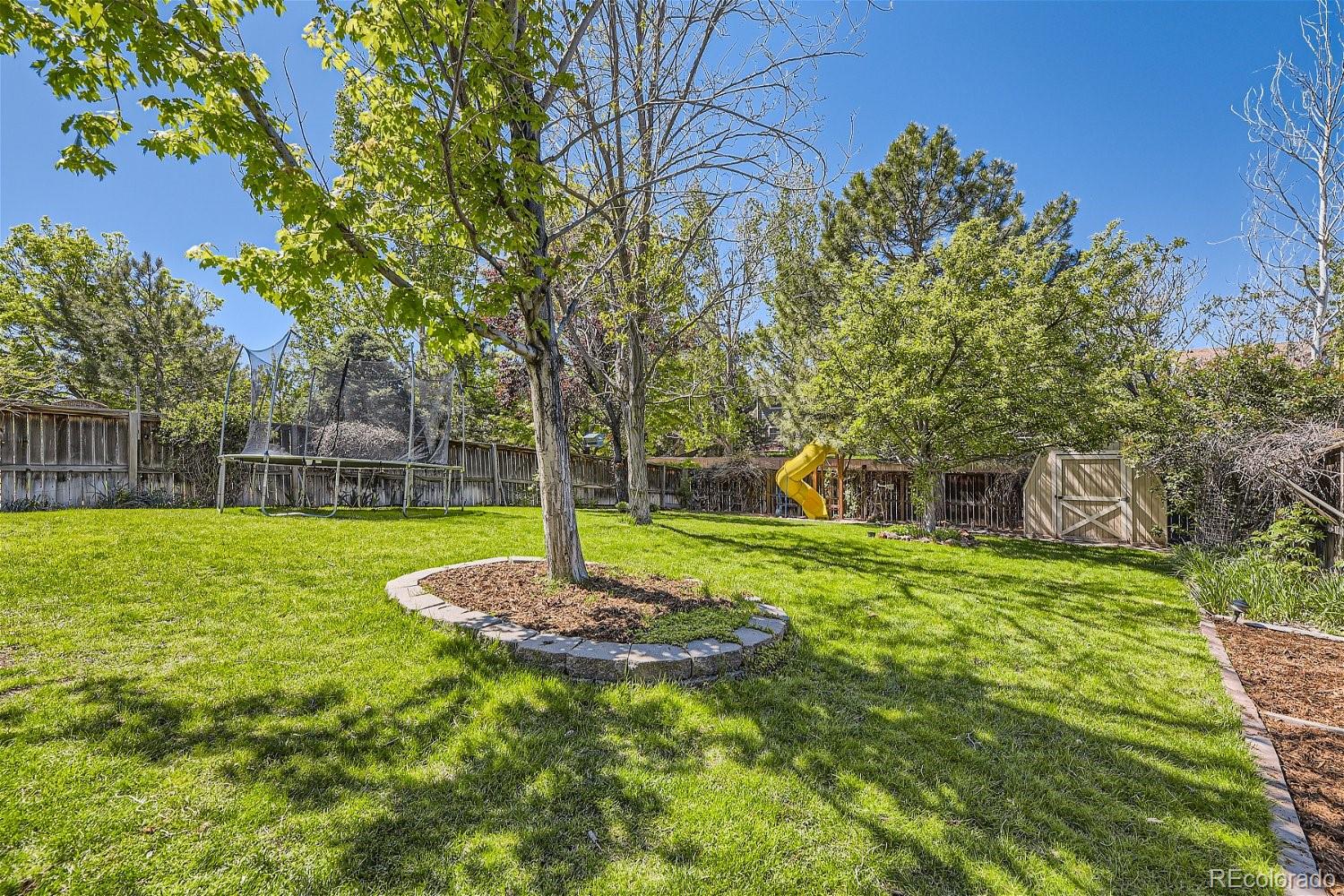9744 South Castle Ridge Circle Highlands Ranch, CO 80129 - Photo 27 of 28 a front view of a house with a yard