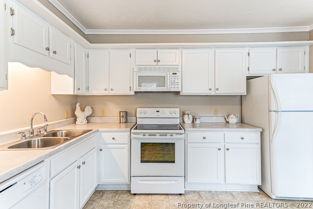 911 Anarine Road Fayetteville, NC 28303 - Photo 11 of 32 a kitchen with cabinets appliances and a sink