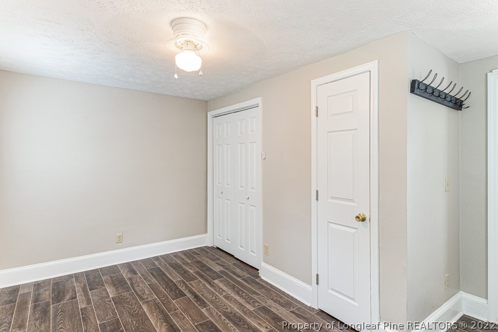 911 Anarine Road Fayetteville, NC 28303 - Photo 14 of 32 a view of a room with wooden floor and a ceiling fan