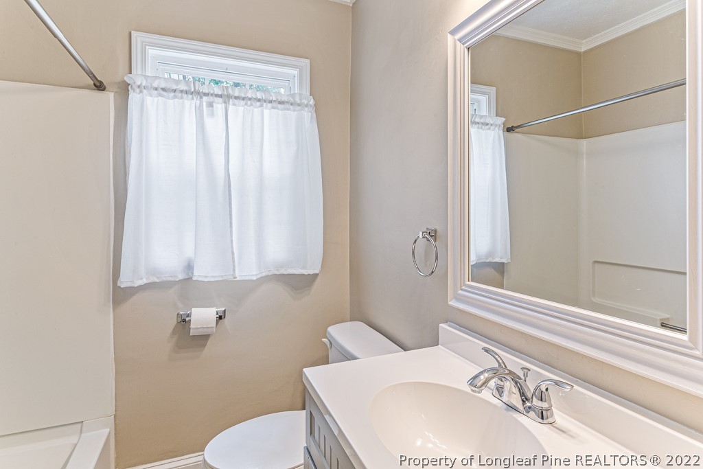 911 Anarine Road Fayetteville, NC 28303 - Photo 17 of 32 a bathroom with a sink toilet and shower
