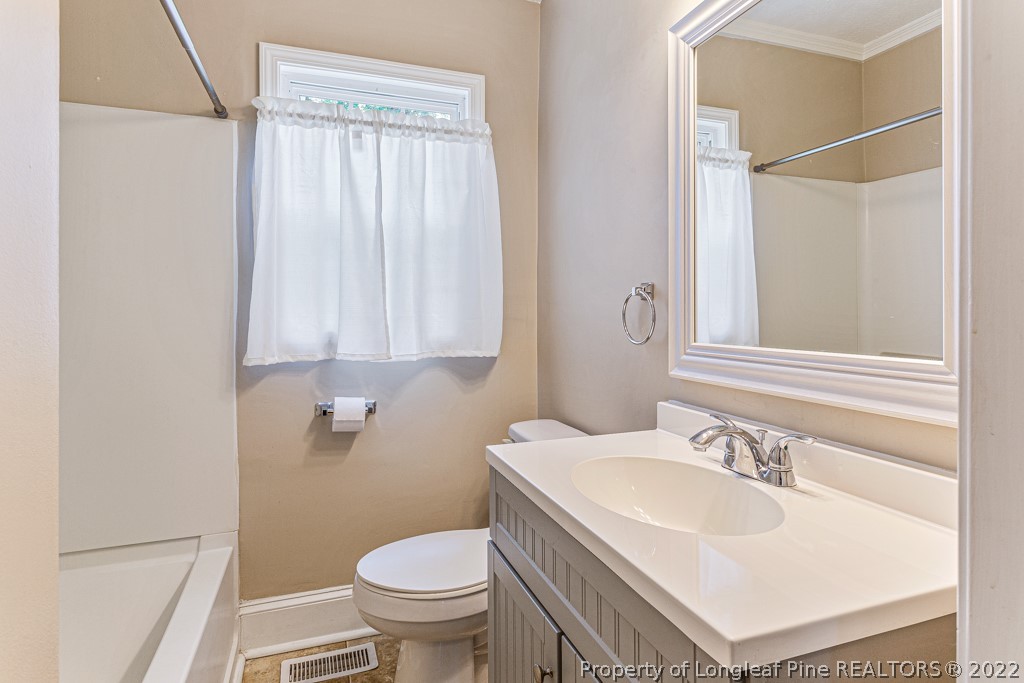911 Anarine Road Fayetteville, NC 28303 - Photo 18 of 32 a bathroom with a sink toilet and shower