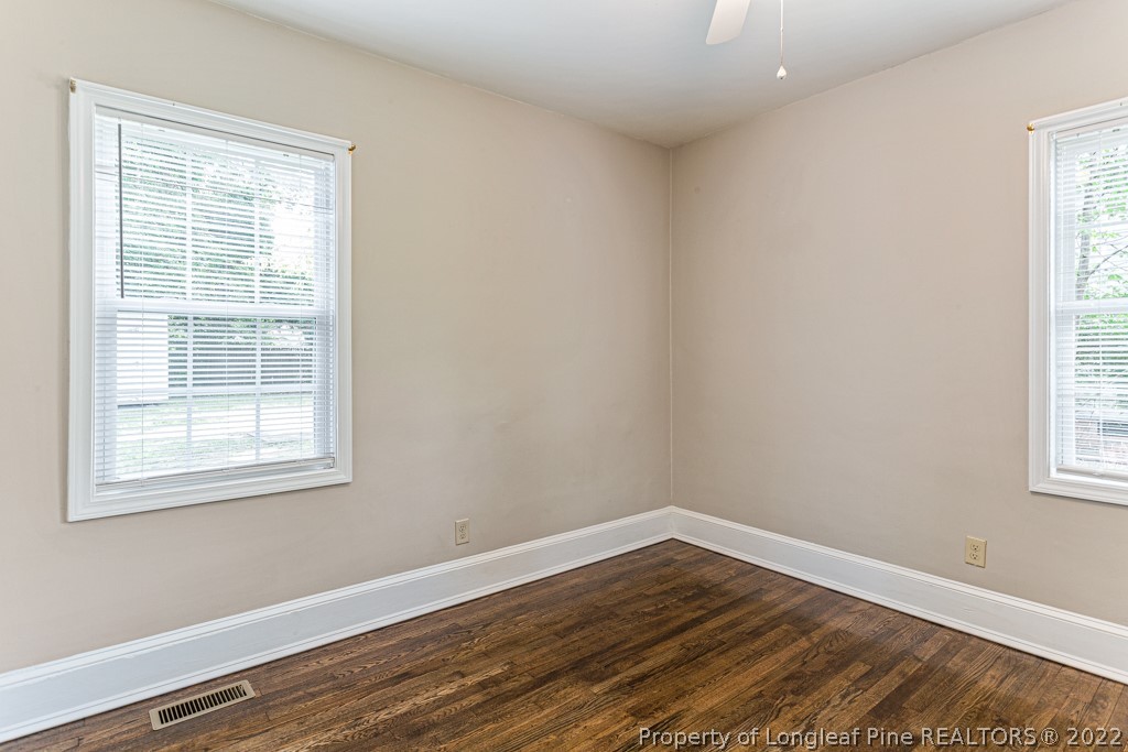 911 Anarine Road Fayetteville, NC 28303 - Photo 19 of 32 a view of an empty room with wooden floor and a window