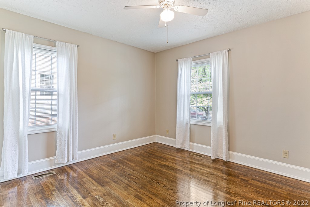 911 Anarine Road Fayetteville, NC 28303 - Photo 21 of 32 a view of an empty room with wooden floor and a window