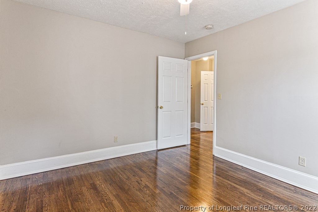 911 Anarine Road Fayetteville, NC 28303 - Photo 22 of 32 a view of an empty room with wooden floor