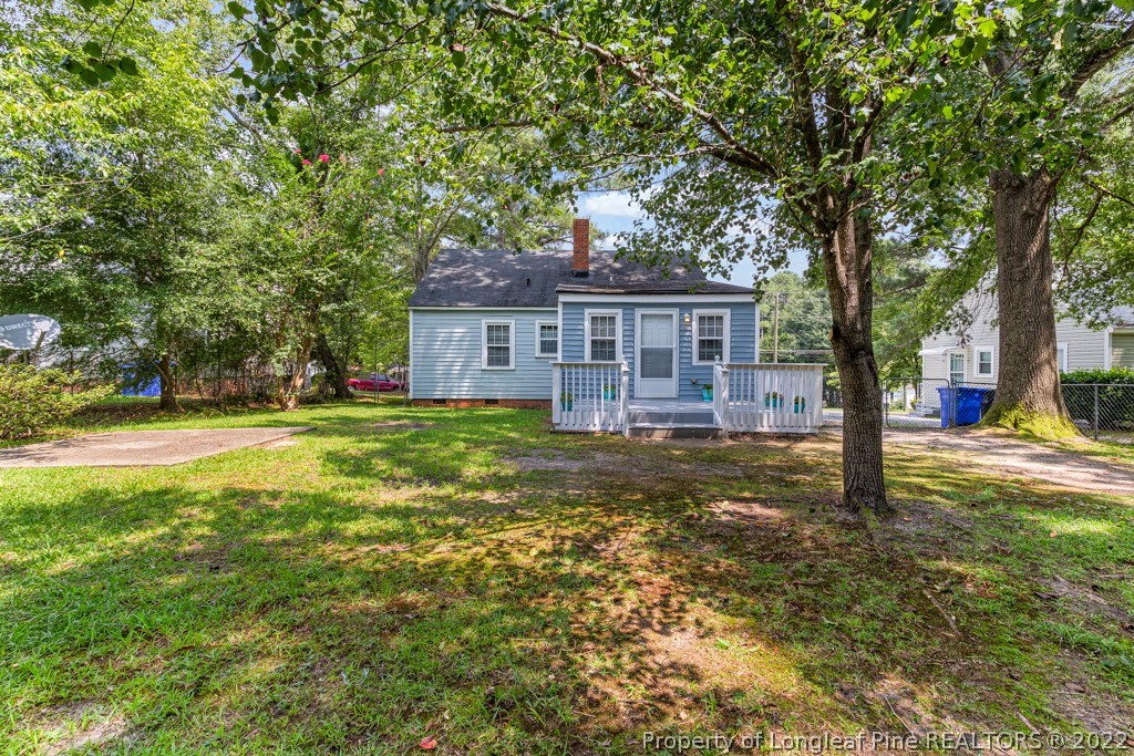 911 Anarine Road Fayetteville, NC 28303 - Photo 29 of 32 a view of a house with pool and trees in the background