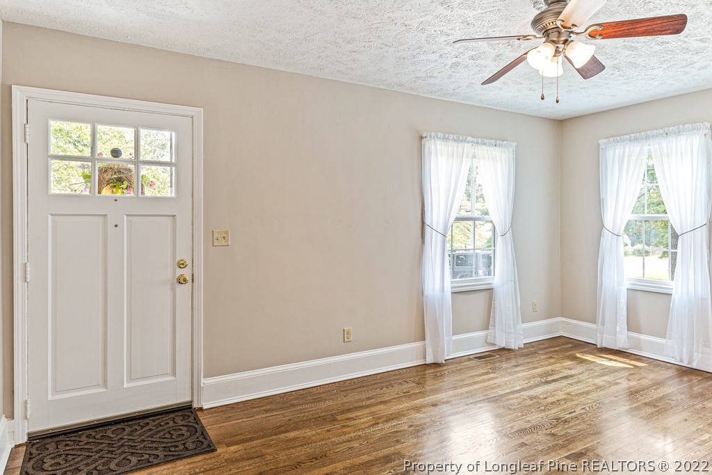 911 Anarine Road Fayetteville, NC 28303 - Photo 5 of 32 a view of an empty room with wooden floor and a window