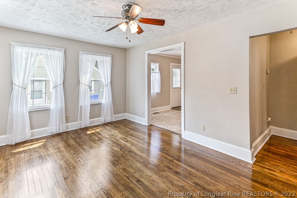 911 Anarine Road Fayetteville, NC 28303 - Photo 6 of 32 a view of an empty room with wooden floor and a window