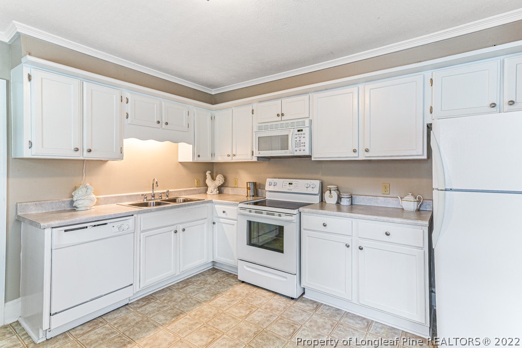 911 Anarine Road Fayetteville, NC 28303 - Photo 10 of 32 a kitchen with cabinets appliances a sink and a counter space