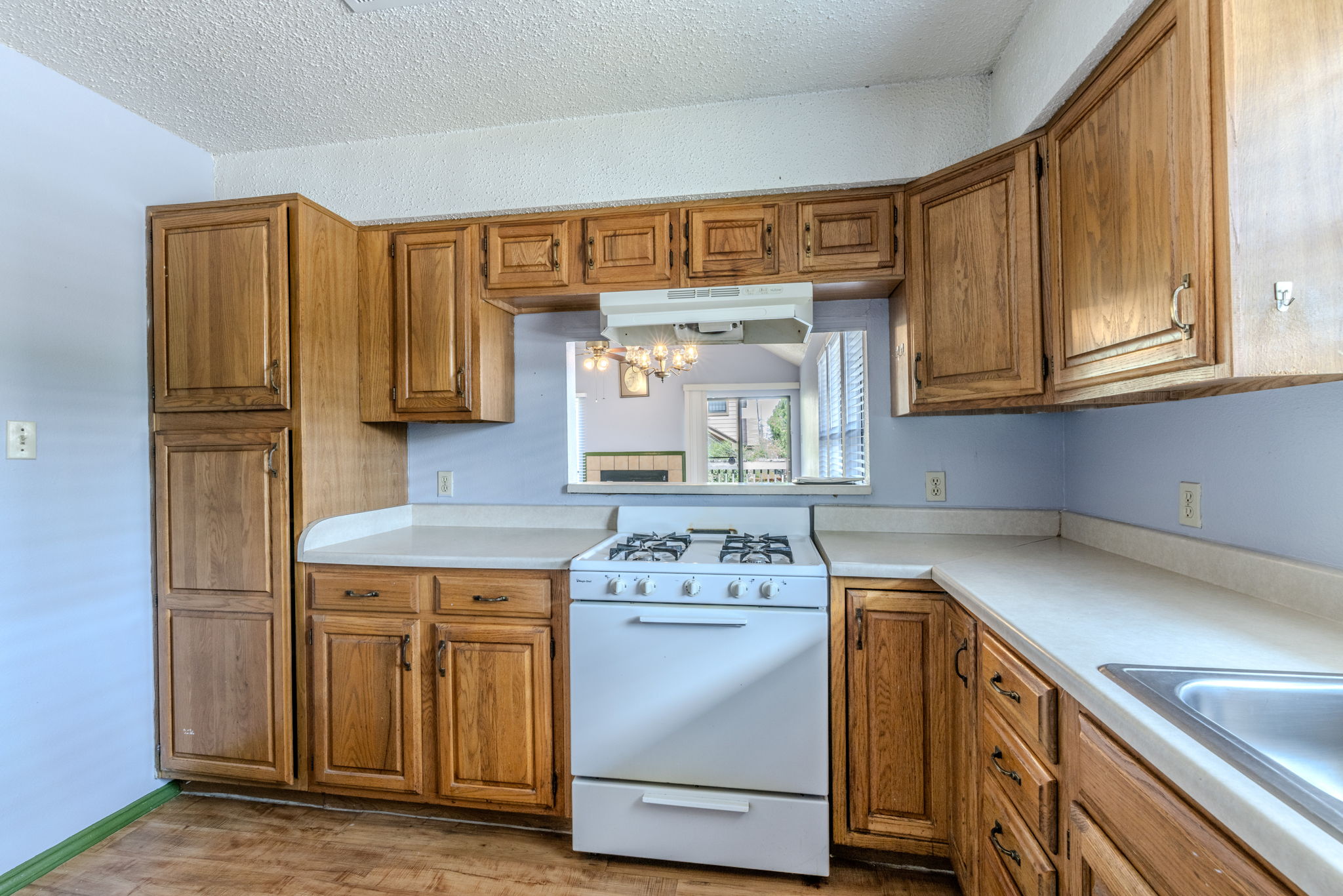 2000 Kenneth Avenue, Unit B Austin, TX 78741 - Photo 8 of 22 Well-equipped kitchen offers abundant wood cabinetry and a convenient pass-through window.
